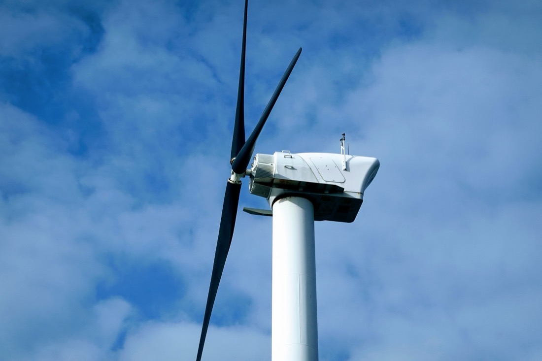Wind turbine nacelle and blades against sky